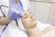 Skin care. Young woman receiving facial beauty treatment. Facial therapy. Anti-aging procedures. Tratamientos facial
